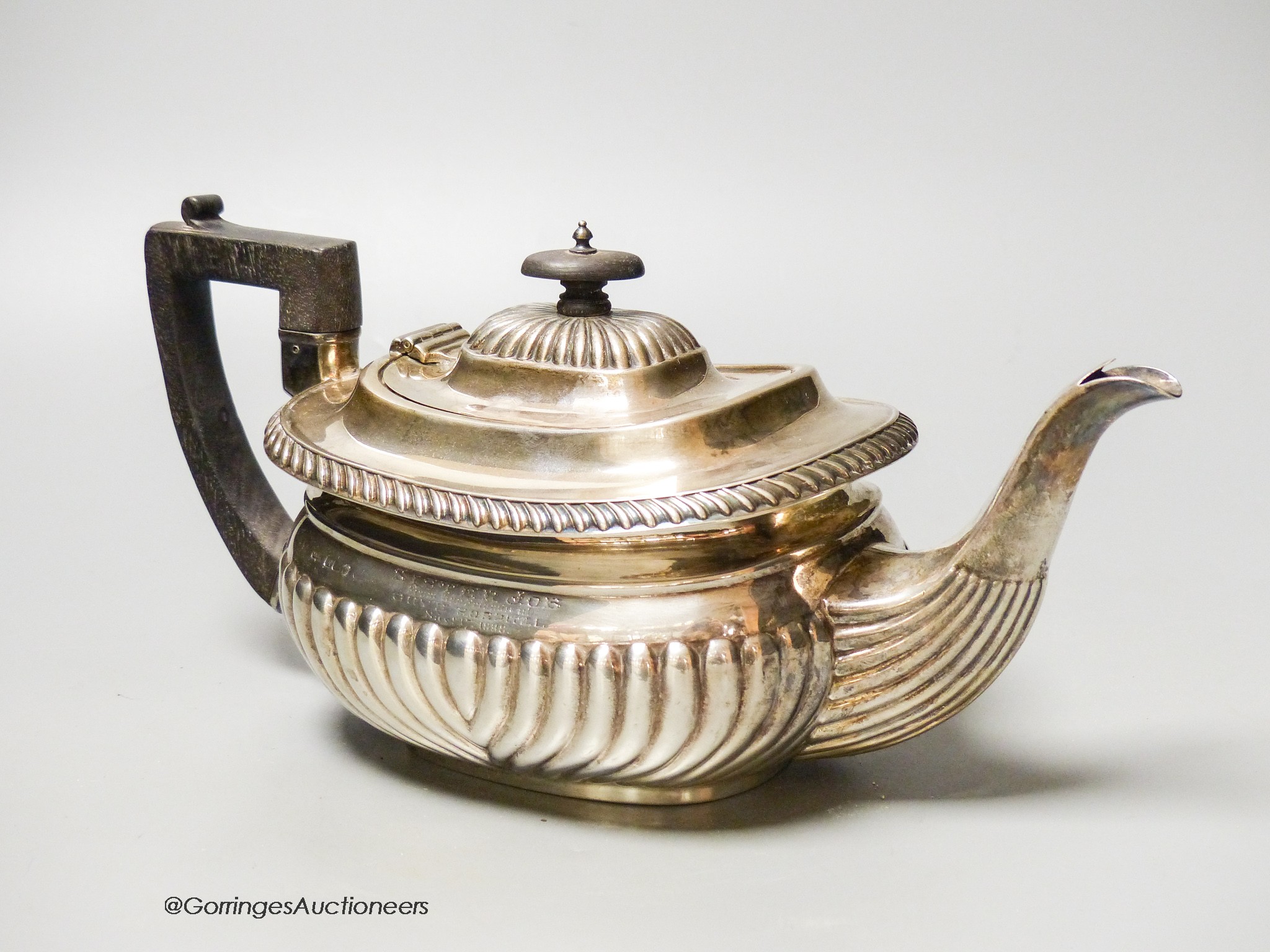 A Mappin & Webb fluted silver teapot, Sheffield, (marks rubbed) presented to ‘Sister Job, From Her Friends at Guy’s Hospital, 1898, gross 23 oz.